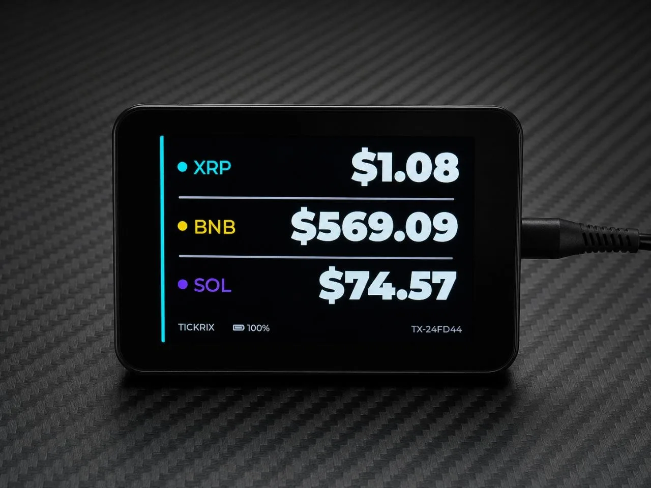A Tickrix bitcoin price ticker display on a desk showing live cryptocurrency prices